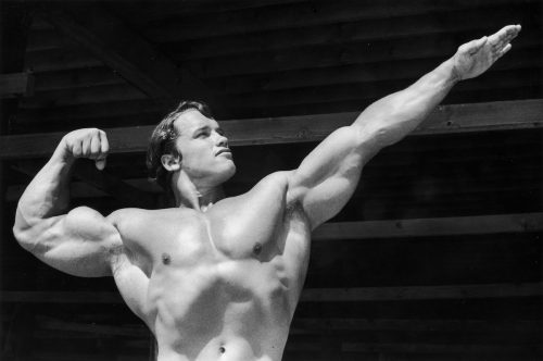 Arnold Schwarzenegger doing a bodybuilding pose circa 1966