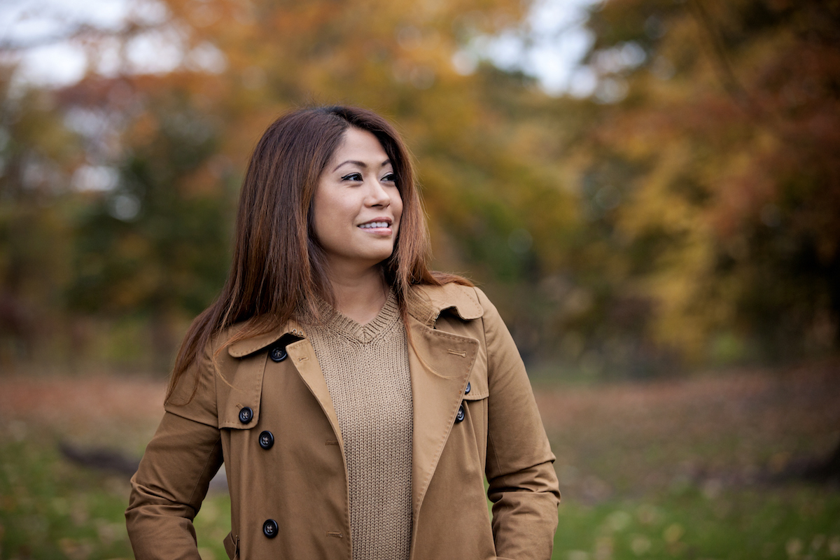 Asian woman posing outdoor in the park on a beautiful Autumn day.