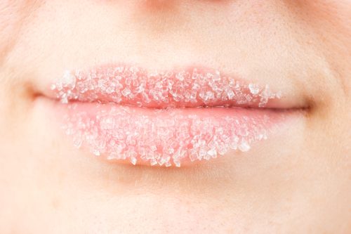 Close up of a woman's lips with exfoliate on them