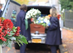 Funeral procession with flowers in car