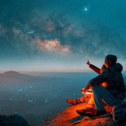 A couple looking at the Milky Way in the night sky