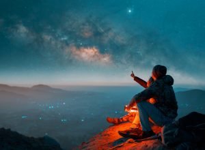 A couple looking at the Milky Way in the night sky