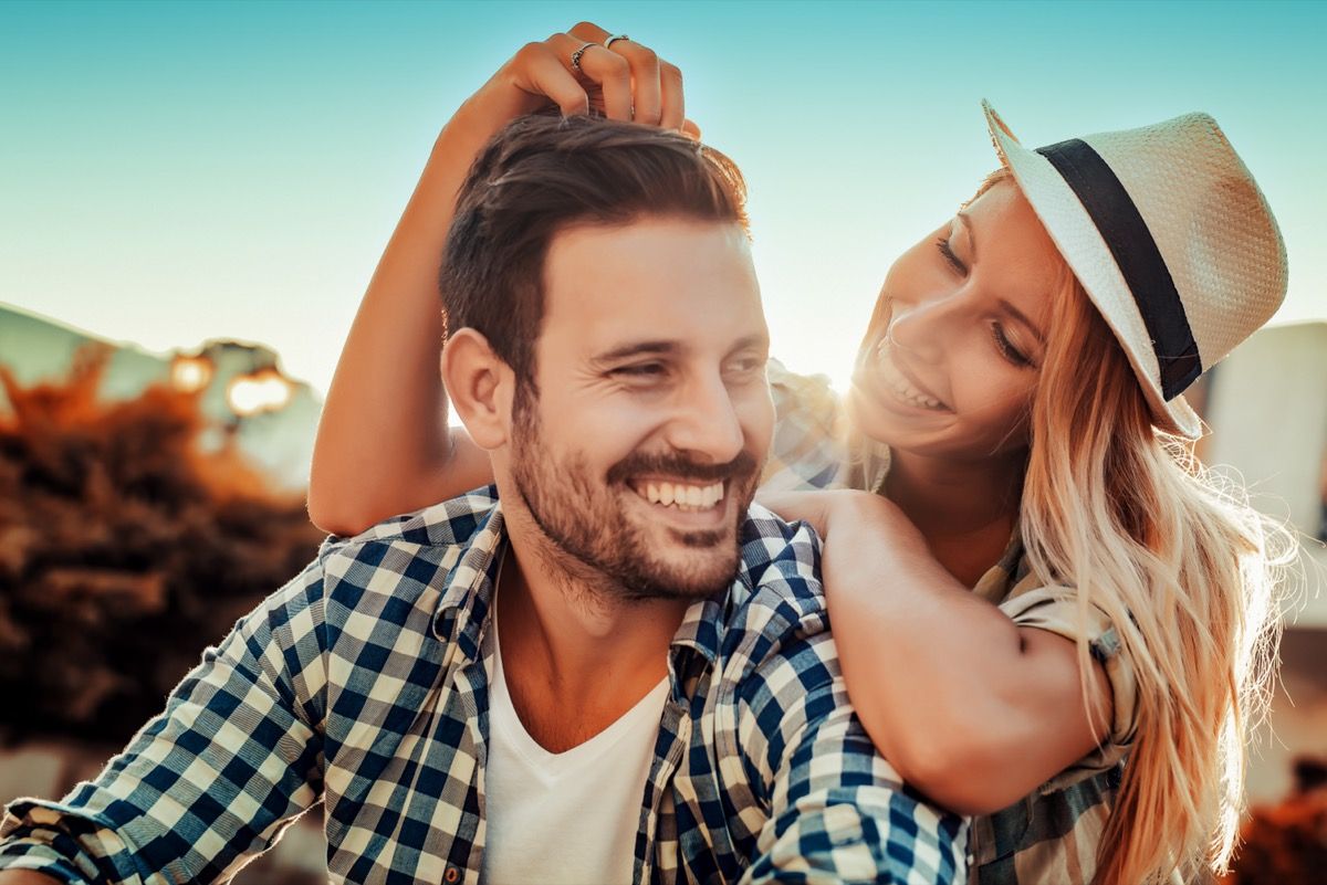 young man and woman cuddling outside