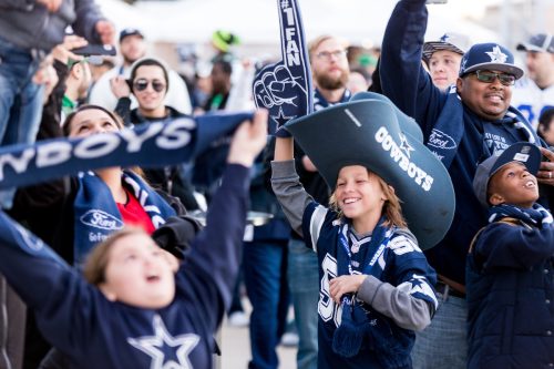A group of Dallas Cowboys football fans cheering
