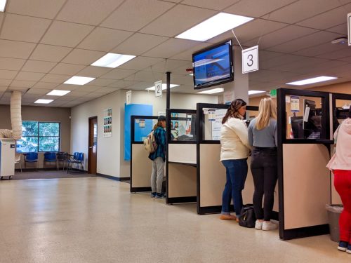 Bellevue, WA USA - November 1st, 2019: People renewing license ID at counter at the DMV in Bellevue, WA.