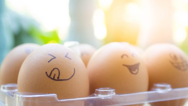 funny eggs with painted face in the box