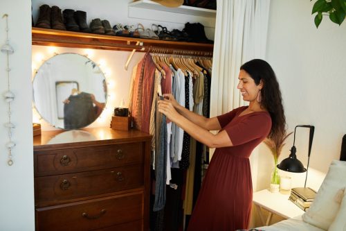 woman picking item out of closet