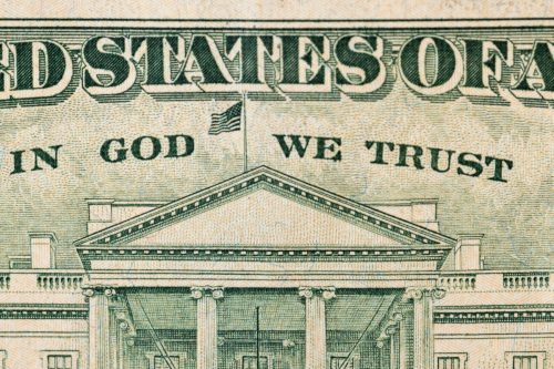 close up of phrase "in god we trust" on one dollar bill