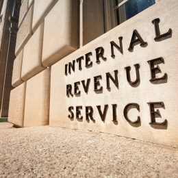A close up of a sign that says Internal Revenue Service outside the IRS headquarters in Washington, D.C.