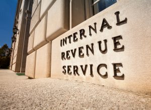 A close up of a sign that says Internal Revenue Service outside the IRS headquarters in Washington, D.C.