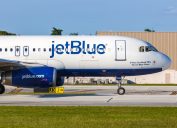 A JetBlue plane on the runway at an airport