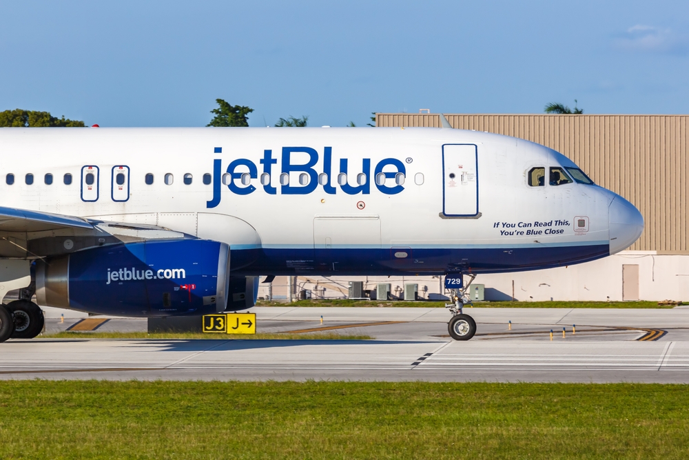 A JetBlue plane on the runway at an airport