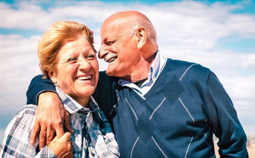 mature man and woman laughing and embracing