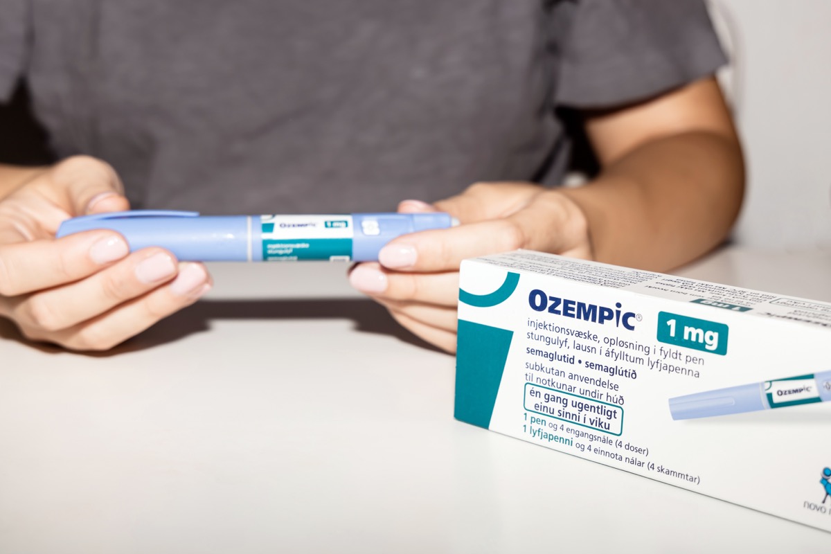 Female hands holding an insulin pen. Ozempic Insulin injection pen or insulin cartridge pen for diabetics. Medical equipment for diabetes parients. Copenhagen, Denmark - September 4, 2023.