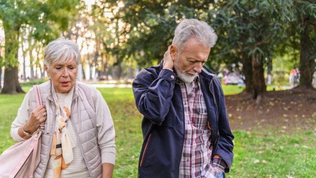 A Senior Couple is Trying to Solve the Problems While Walking in a Public Park.