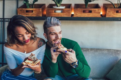 quirky couple eating pizza