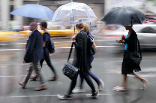 commuters walking to work in the rain