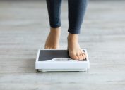 woman stepping on scale