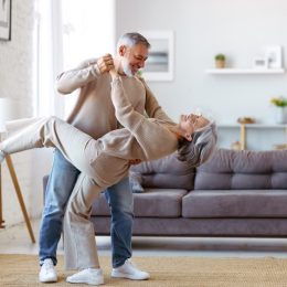 senior couple dancing in living room