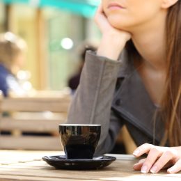 Impatient woman waiting on a cafe terrace