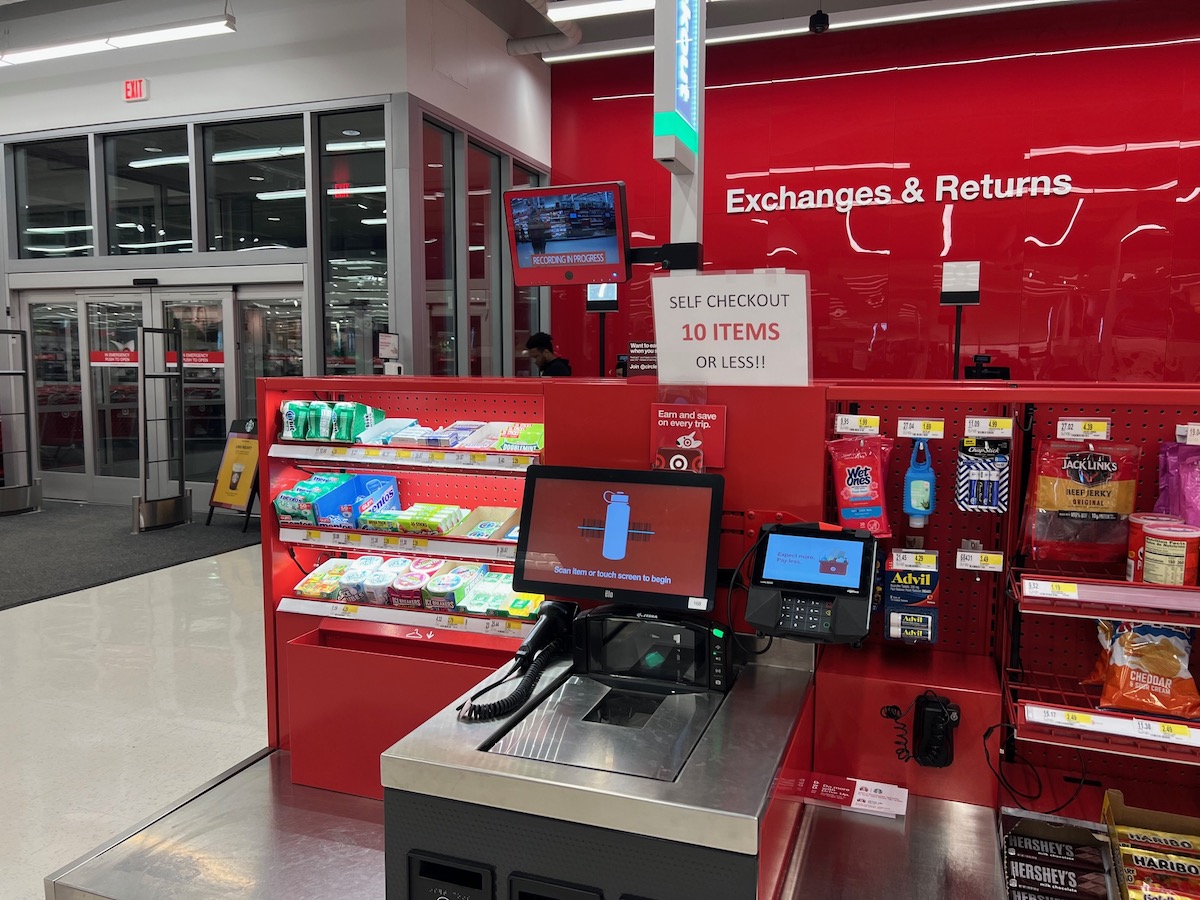 A self-checkout register at a Target store showing a sign for a 10-item limit