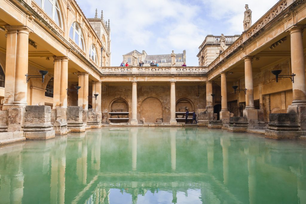 A Roman Bath in Bath, England, surrounded by columns