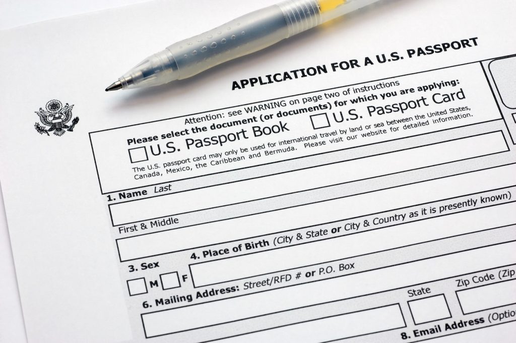 A close up of a pen on top of a U.S. passport application