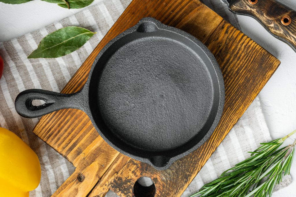 A vintage cast iron pan on a cutting board