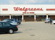 "Chicago, USA - September 17, 2012: A lady shopper leaves a Walgreens store and crosses the parking lot to her car. Walgreens was established in Chicago in 1901, just a few miles from this 24 hour store - one of over 8300 in the USA."