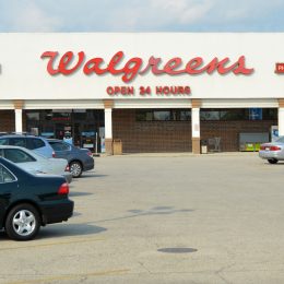 "Chicago, USA - September 17, 2012: A lady shopper leaves a Walgreens store and crosses the parking lot to her car. Walgreens was established in Chicago in 1901, just a few miles from this 24 hour store - one of over 8300 in the USA."