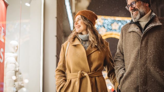 Mature couple in the city walking and having fun on winter day.