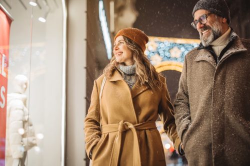 Mature couple in the city walking and having fun on winter day.