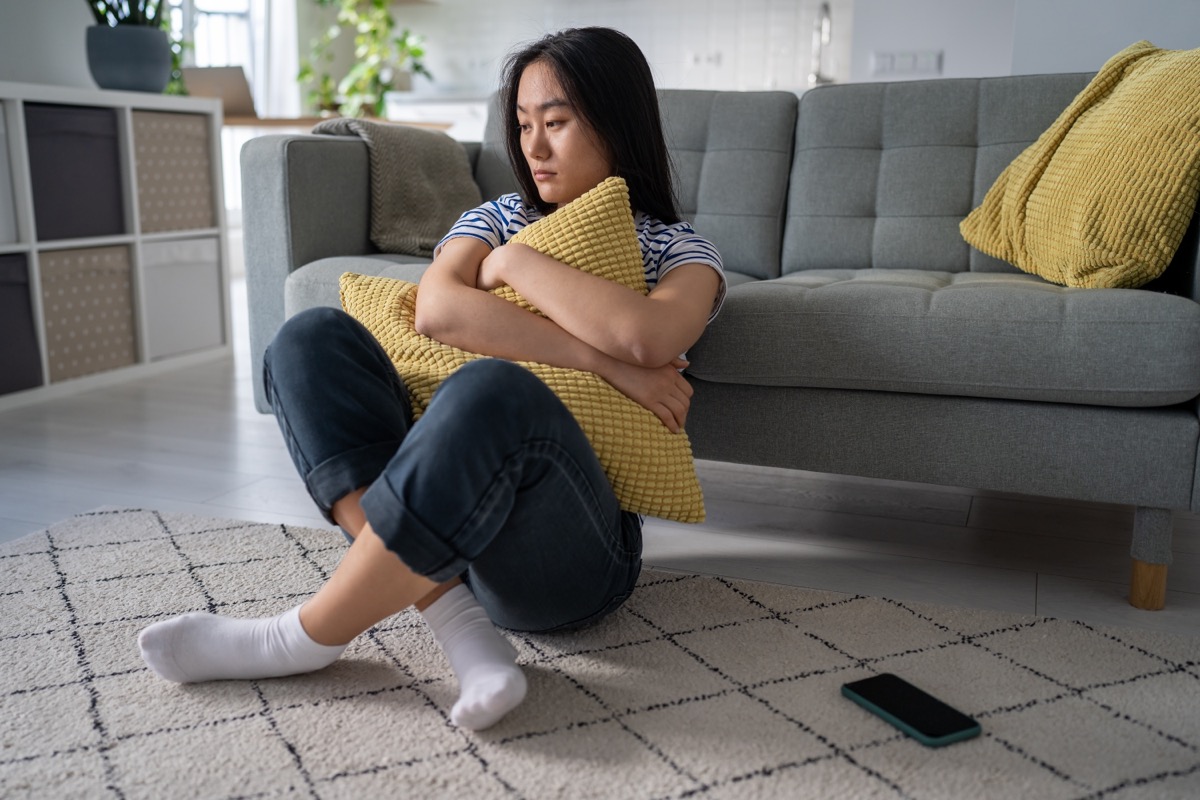 Girl Sitting Alone Holding a Pillow