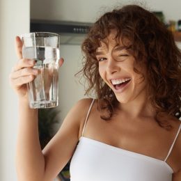 Happy Young Woman Drinking Water
