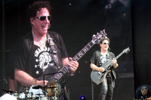 Speedway, IN/USA - May 27, 2016: Guitarist Neal Schon of Journey performs with a video of himself onstage during an outdoor concert in Indiana.
