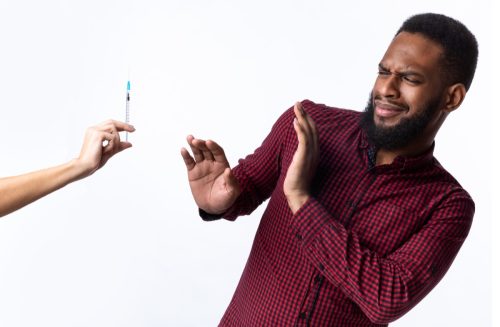man avoiding needles due to a fear of injection