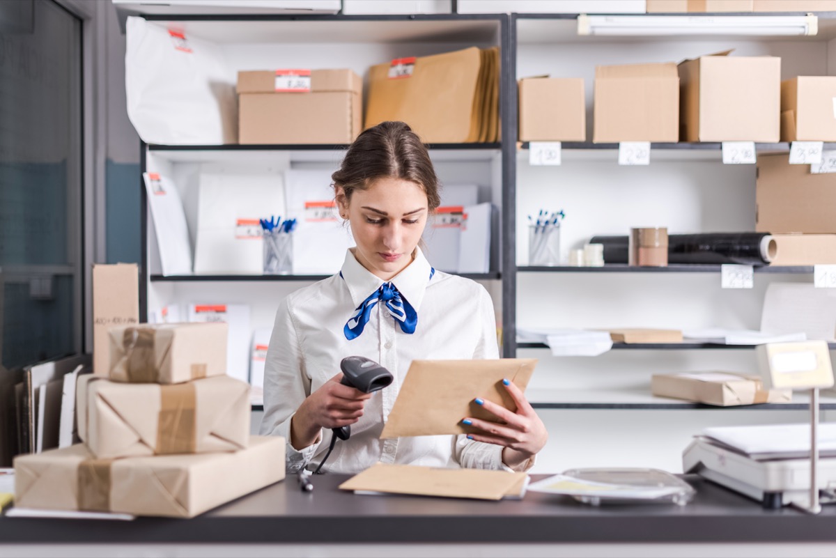 young woman working at the USPS post office
