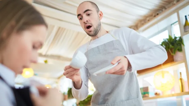 Waiter Spilling Coffee on Woman