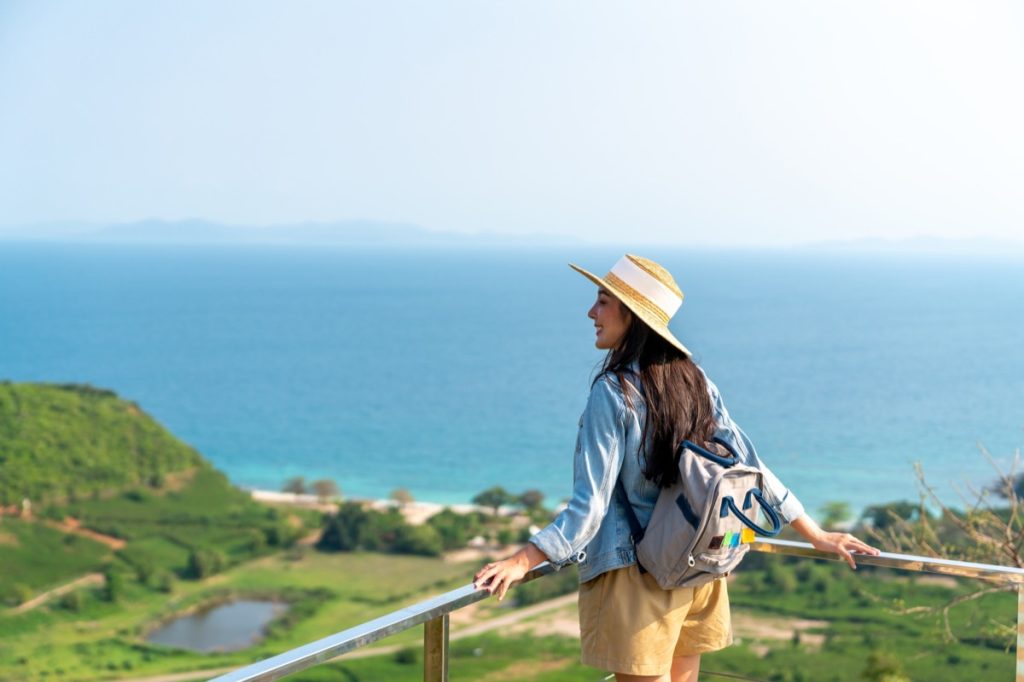 woman standing at railing overlooking a beautiful view
