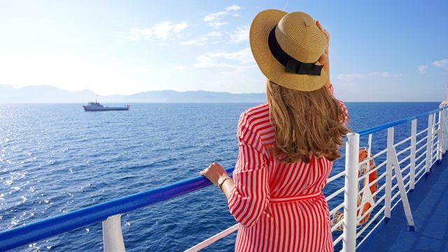 Cruise ship vacation holiday. Back view of relaxed fashion woman enjoying travel on cruise liner.