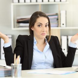Young Woman Shrugging in Office