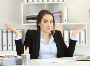 Young Woman Shrugging in Office