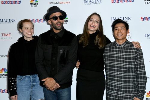 Shiloh Jolie-Pitt, artist JR, Angelina Jolie, and Pax Jolie-Pitt at the premiere of "Paper & Glue: A JR Project" in 2021