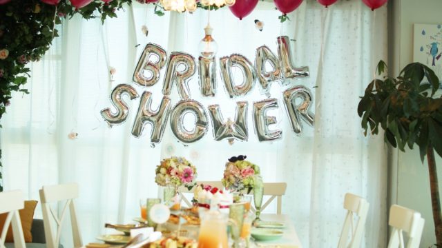 bride celebrating her upcoming wedding with balloons, table setting, and bridal shower games