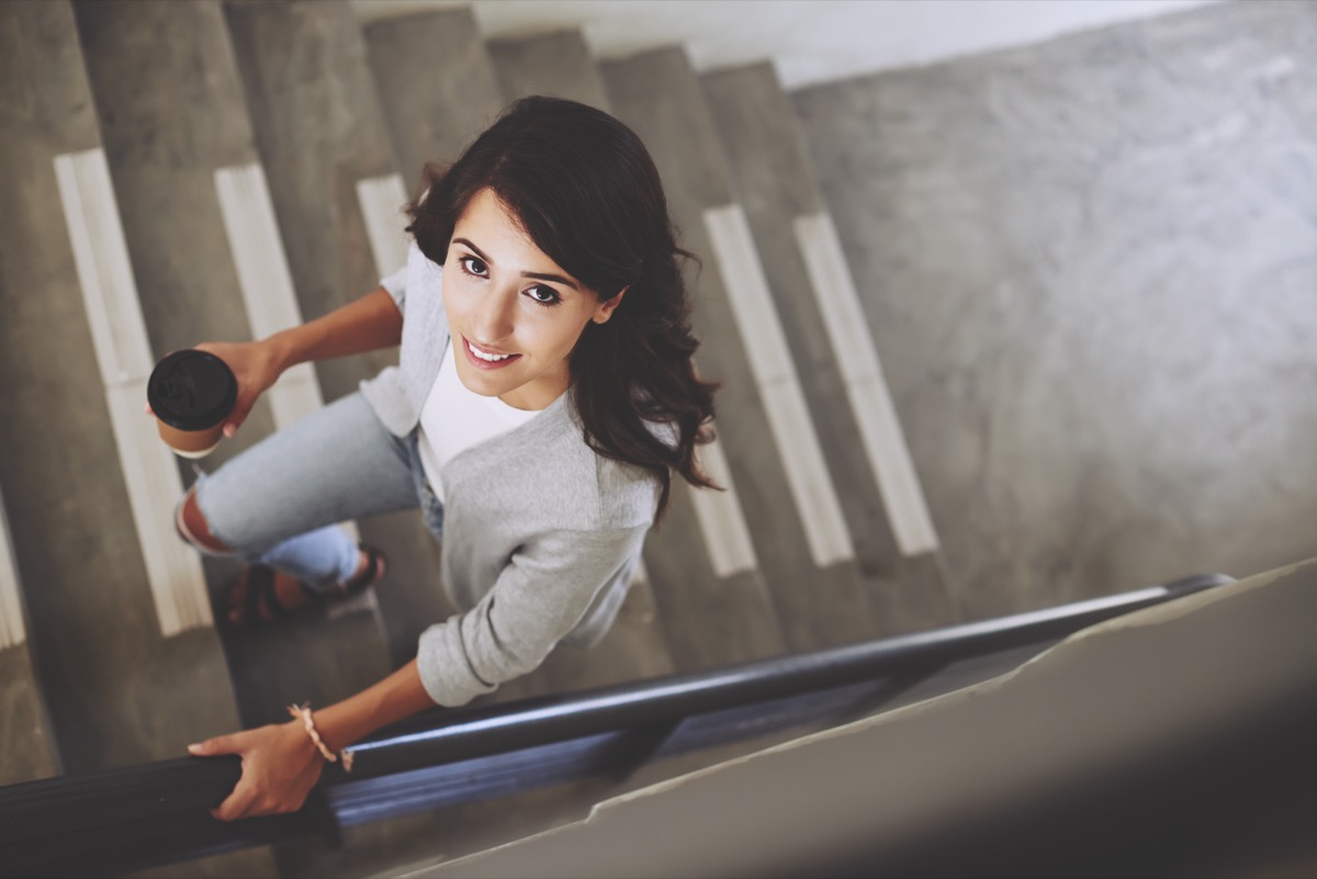 Portrait of woman walking up the stair.