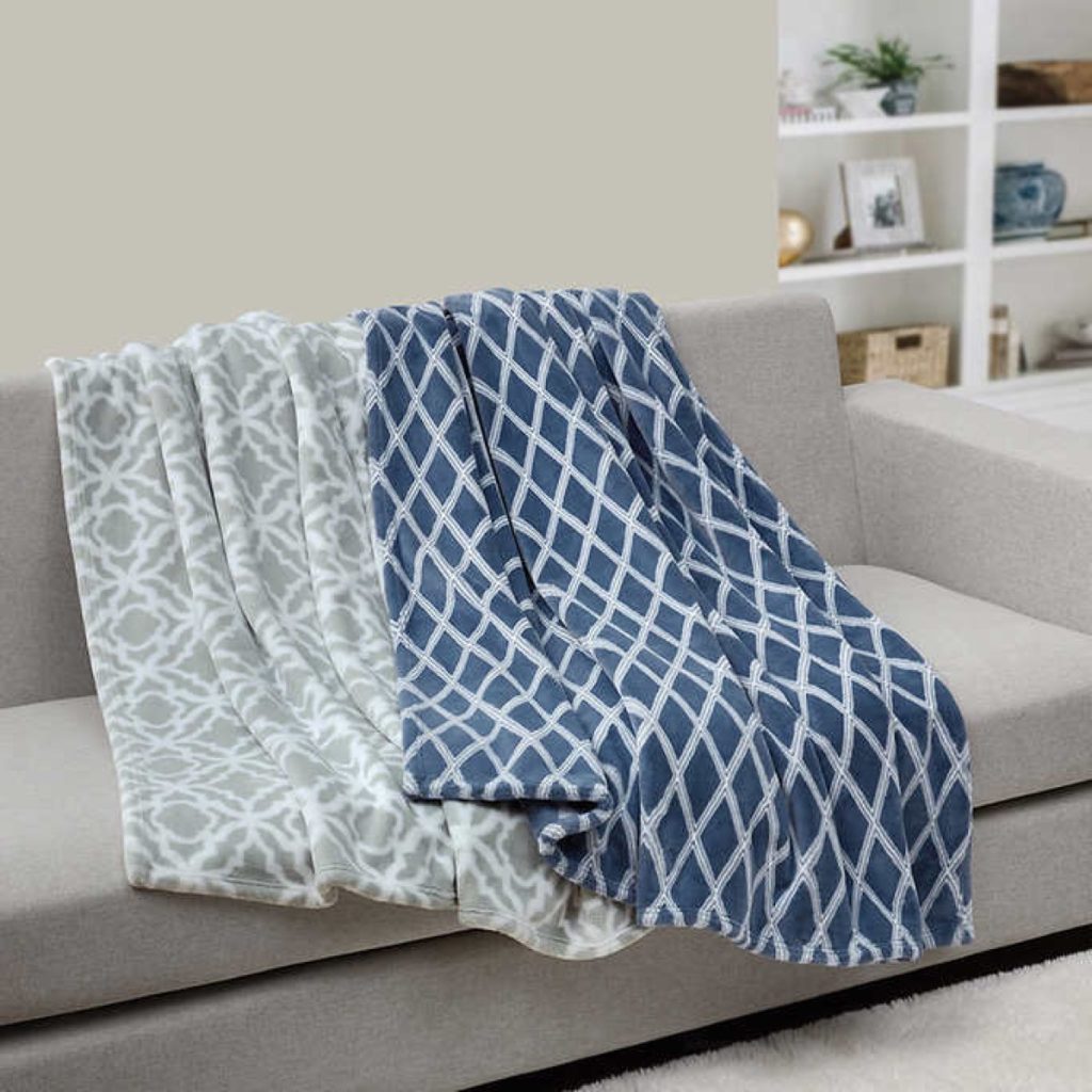A pair of casual living plush throw blankets on a couch
