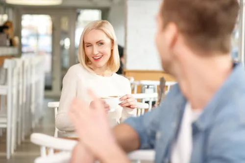 woman winking at a man in a cafe