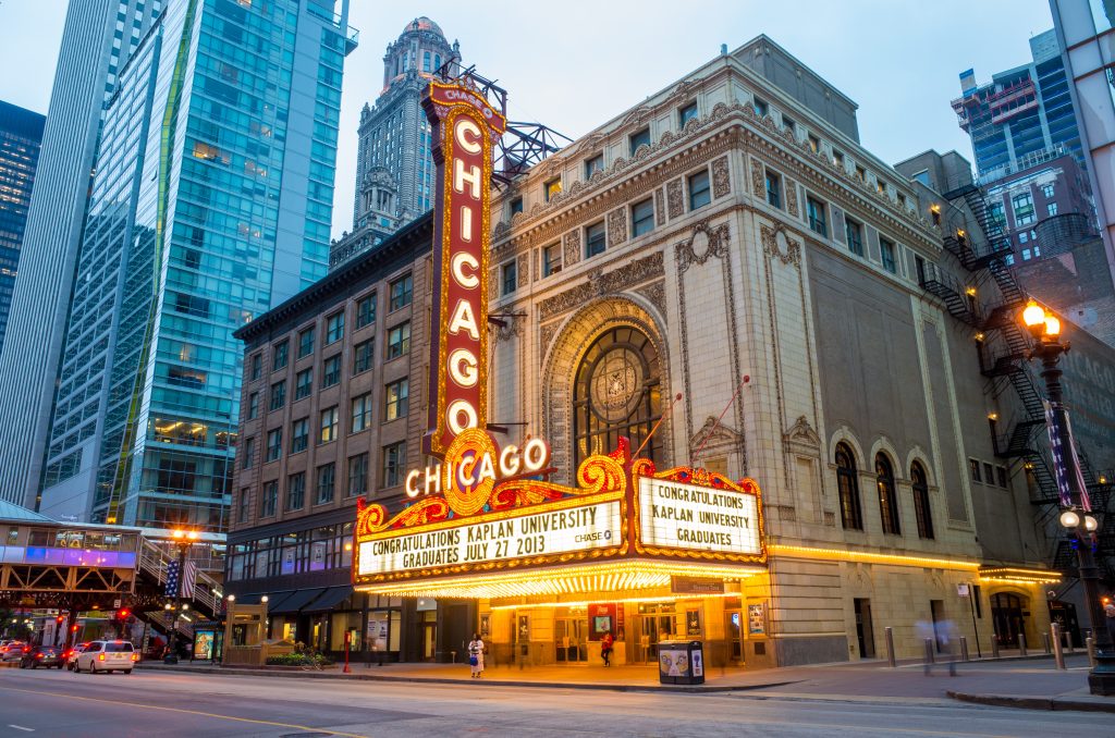 THe Chicago Theater sign illuminates downtown Chicago.