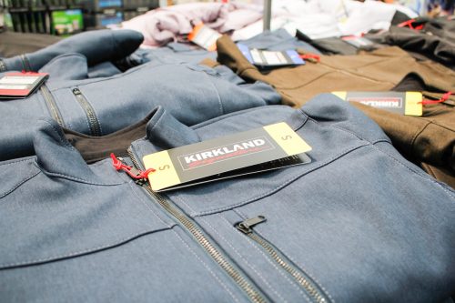A view of stacks of folded Kirkland Signature zipper jackets, on display at a local Costco.