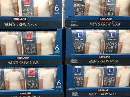 Packages of Kirkland Signature Men's Crew Neck T-shirts on display at the bulk warehouse store.